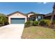 Charming home with a well-maintained lawn and attached garage at 16313 Treasure Point Dr, Wimauma, FL 33598