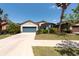 Well-kept home with lush front yard landscaping and a driveway at 16313 Treasure Point Dr, Wimauma, FL 33598