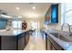 Spacious kitchen with granite countertops, stainless steel sink, and an open layout to the dining and living areas at 16313 Treasure Point Dr, Wimauma, FL 33598
