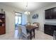 Dining area with a wooden table, seating for six, and access to an outdoor space at 16313 Treasure Point Dr, Wimauma, FL 33598