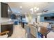 Bright, modern kitchen with stainless steel appliances, dark wood cabinets, and open layout to the living area at 16313 Treasure Point Dr, Wimauma, FL 33598