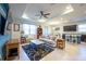 Bright living room featuring an open floor plan, ceiling fan, and access to the dining area at 16313 Treasure Point Dr, Wimauma, FL 33598
