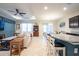 Bright living room featuring an open floor plan, ceiling fan, and access to the dining area at 16313 Treasure Point Dr, Wimauma, FL 33598