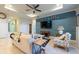 Inviting living room showcasing stylish decor, paneling, and an open layout with plenty of natural light at 16313 Treasure Point Dr, Wimauma, FL 33598