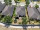 This backyard features mature trees, a small patio and privacy fencing at 16313 Treasure Point Dr, Wimauma, FL 33598