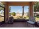 Cozy screened patio with comfortable seating and views of the fenced backyard at 16313 Treasure Point Dr, Wimauma, FL 33598