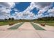Community shuffleboard courts with multiple benches available for neighborhood residents to enjoy at 16313 Treasure Point Dr, Wimauma, FL 33598