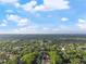 An aerial shot showcases a lush neighborhood with a home surrounded by trees, near a lake and golf course at 16411 Lake Byrd Dr, Tampa, FL 33618