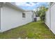 Exterior view of a backyard featuring green grass and white fencing at 16411 Lake Byrd Dr, Tampa, FL 33618