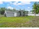 A beautifully maintained backyard featuring a lush lawn and modern home exterior at 16411 Lake Byrd Dr, Tampa, FL 33618