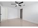 Clean bedroom with tile floors, neutral color scheme, and closet with sliding doors at 16411 Lake Byrd Dr, Tampa, FL 33618