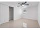 Neutral bedroom with tile flooring, a ceiling fan, a closet with sliding doors, and a window at 16411 Lake Byrd Dr, Tampa, FL 33618