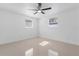 Bright bedroom featuring two windows and neutral tile flooring at 16411 Lake Byrd Dr, Tampa, FL 33618