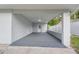 Spacious carport featuring modern flooring, fresh paint, and a convenient side entrance at 16411 Lake Byrd Dr, Tampa, FL 33618