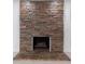 Stone fireplace with stacked stones and hearth offers a beautiful architectural detail in the home at 16411 Lake Byrd Dr, Tampa, FL 33618
