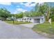 Inviting single-story home with a side carport and manicured lawn at 16411 Lake Byrd Dr, Tampa, FL 33618