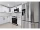 Updated kitchen with stainless steel appliances and white cabinetry at 16411 Lake Byrd Dr, Tampa, FL 33618