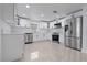 Modern kitchen features white cabinets, stainless steel appliances, and tile flooring at 16411 Lake Byrd Dr, Tampa, FL 33618