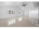 Bright living room featuring a ceiling fan and two windows at 16411 Lake Byrd Dr, Tampa, FL 33618