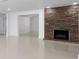 Living room showcasing fireplace with stone surround and smooth, bright white tile floors at 16411 Lake Byrd Dr, Tampa, FL 33618