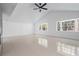 Bright living room featuring a ceiling fan and two windows at 16411 Lake Byrd Dr, Tampa, FL 33618