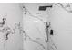 Modern shower with black fixtures and beautiful white marble tile at 16411 Lake Byrd Dr, Tampa, FL 33618