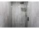 A contemporary shower with gray tiles, rainfall shower head and modern fixtures at 16411 Lake Byrd Dr, Tampa, FL 33618