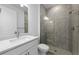 Modern bathroom featuring a glass-enclosed shower, sleek vanity, and neutral tile at 17093 Moonflower Dr, Venice, FL 34293