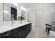 Bathroom featuring double vanity sinks and linen closet at 17093 Moonflower Dr, Venice, FL 34293