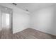 Cozy bedroom features wood-look tile flooring and a closet with modern sliding doors at 17093 Moonflower Dr, Venice, FL 34293