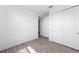 Bright bedroom boasts wood-look tile flooring and a closet with sleek sliding doors at 17093 Moonflower Dr, Venice, FL 34293