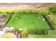 Aerial view of the fenced community dog park, with lush green grass at 17093 Moonflower Dr, Venice, FL 34293