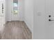 Welcoming entryway featuring a decorative front door and stylish gray wood-look flooring at 17093 Moonflower Dr, Venice, FL 34293