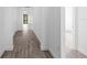 Hallway showcasing neutral walls and gray wood-look flooring that runs the length of the home at 17093 Moonflower Dr, Venice, FL 34293