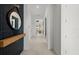 Clean hallway featuring tile floors, white walls, and leading to the living area of the home at 17093 Moonflower Dr, Venice, FL 34293