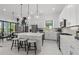 Contemporary kitchen with stainless steel appliances, quartz countertops, and a center island with seating at 17093 Moonflower Dr, Venice, FL 34293