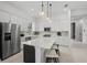 Modern kitchen featuring white cabinetry, a center island with seating, and stainless steel appliances at 17093 Moonflower Dr, Venice, FL 34293
