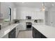 Bright kitchen features white cabinets, stainless appliances, and light tile flooring at 17093 Moonflower Dr, Venice, FL 34293