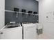 Modern laundry room with new washer, dryer, and utility sink at 17093 Moonflower Dr, Venice, FL 34293