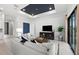 Comfortable living room featuring modern decor, a media center, and large windows for natural light at 17093 Moonflower Dr, Venice, FL 34293