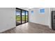 Bright living room featuring sliding glass doors that lead to an outdoor patio space at 17093 Moonflower Dr, Venice, FL 34293
