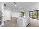 Open-concept design with a modern kitchen and sliding glass doors leading to the outside at 17093 Moonflower Dr, Venice, FL 34293