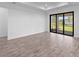 Spacious room featuring tile floors, neutral wall paint and sliding glass doors leading to the backyard at 17093 Moonflower Dr, Venice, FL 34293