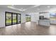 Open-concept living space with sliding glass doors, tile floors, and a modern kitchen at 17093 Moonflower Dr, Venice, FL 34293