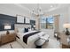 Main bedroom featuring tray ceiling, modern decor, and lots of natural light at 17093 Moonflower Dr, Venice, FL 34293
