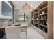 Home office featuring built-in shelving and natural light at 17093 Moonflower Dr, Venice, FL 34293