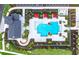 Aerial view of community pool with splash pad, cabanas, and lush landscaping at 17093 Moonflower Dr, Venice, FL 34293