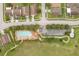 Aerial view of community pool, park, and parking lot surrounded by well-maintained homes at 17413 Garden Heath Ct, Land O Lakes, FL 34638