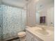 Functional bathroom with a white vanity, standard toilet, and shower with a patterned curtain at 17413 Garden Heath Ct, Land O Lakes, FL 34638