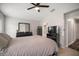Serene bedroom suite with dark furniture, TV, and ensuite bathroom for added convenience at 17413 Garden Heath Ct, Land O Lakes, FL 34638